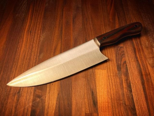 A commissioned chef knife made with AEB-L stainless and black and red stacked micarta