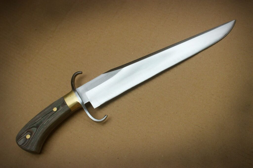 Custom C Guard Regent Bowie from Kailash. Brass hardware with our own forest camo micarta scales.