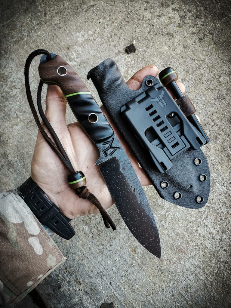 80crv2 with dark brown Micarta and black and toxic green G10, with titanium pins.