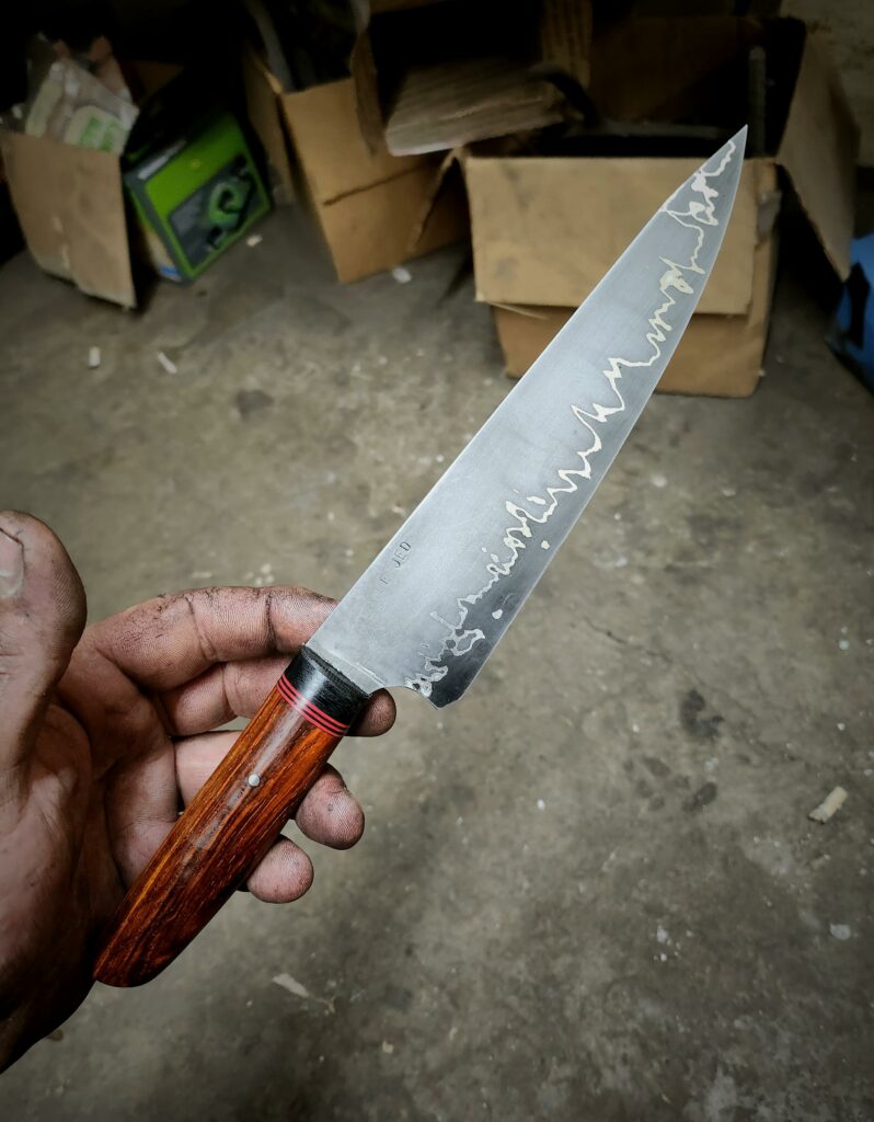 Go mai. 1095 core, nickel, and mild steel jacket. Cocobolo handle.