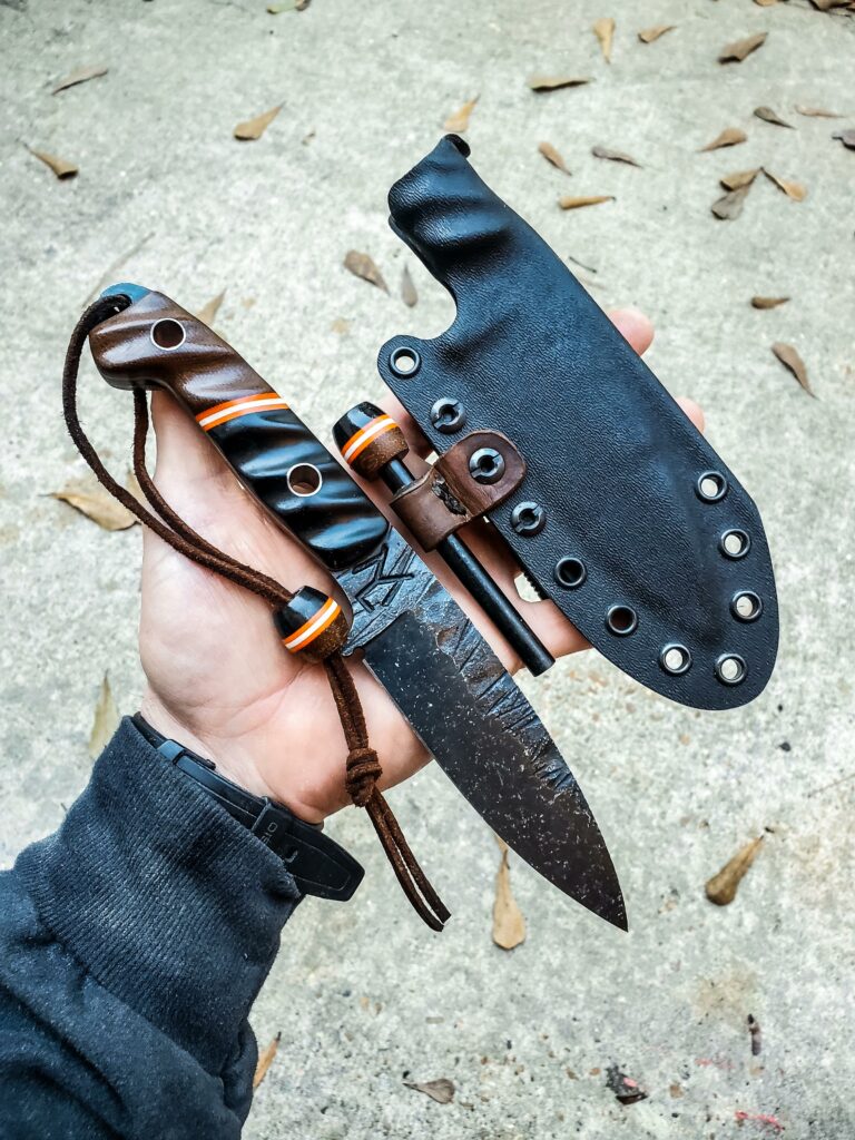 80crv2 with black and orange G10 and some Dark brown Micarta