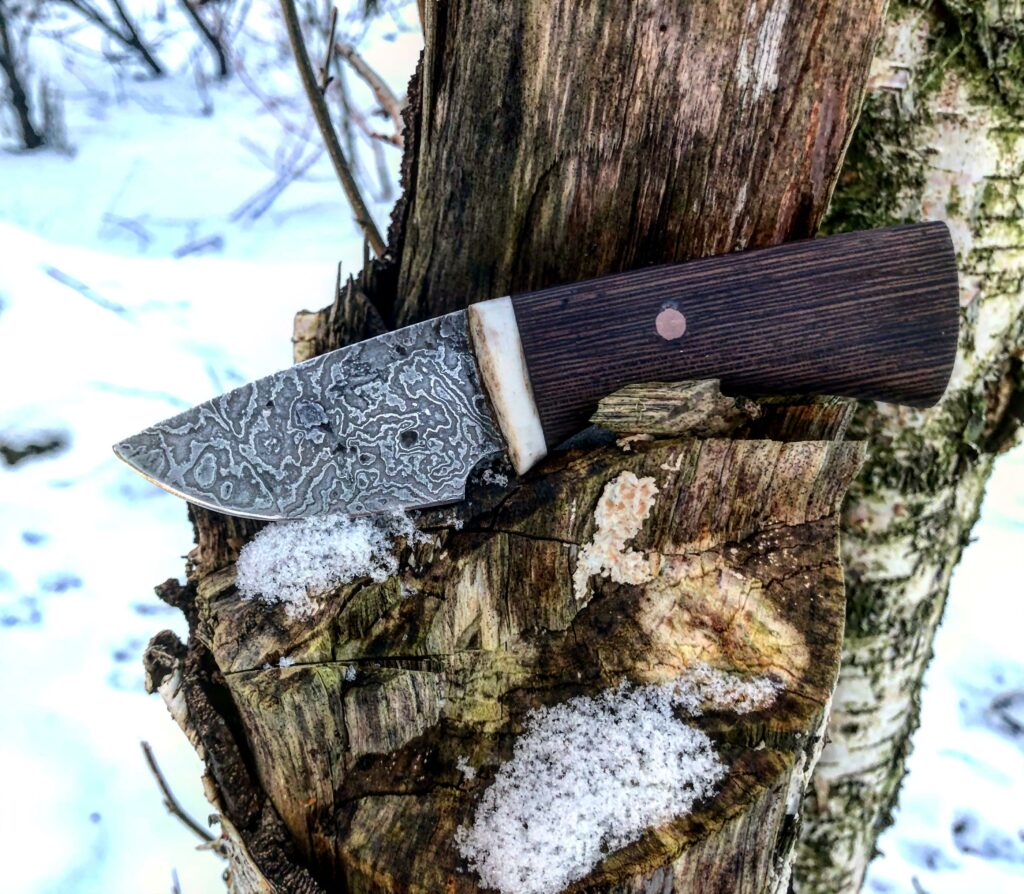A little damascus Neck Knife made by Hellize.