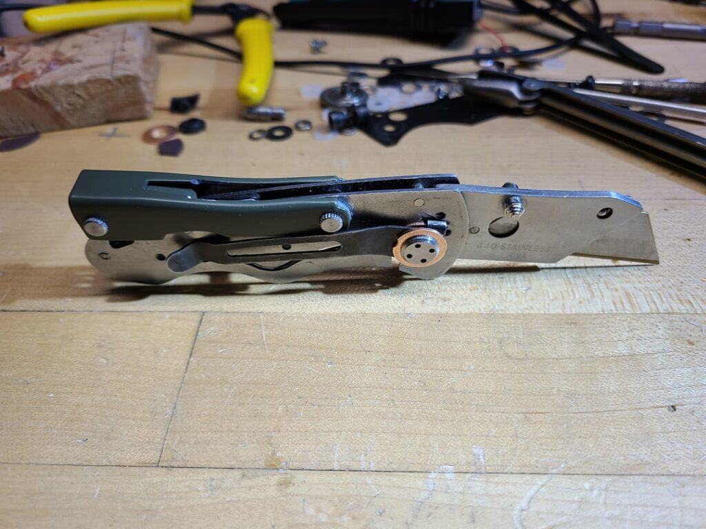 Made this tool from a pile of parts I've been hoarding. Spring assisted box cutter, philips #1&2, can/bottle opener, 2.5mm flat driver/chisel
