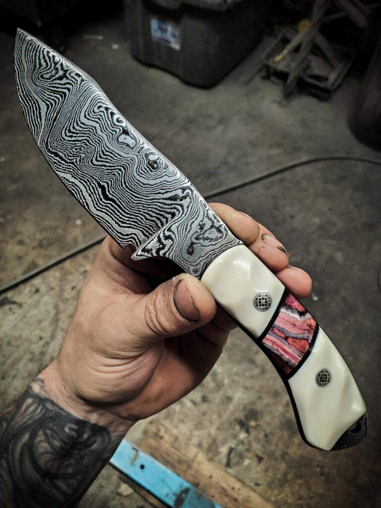 220 layers of 1084 and 15n20. Handles made from1950s stablized Walrus tusk and black G10 and an segment of stablized Mammoth Molar.