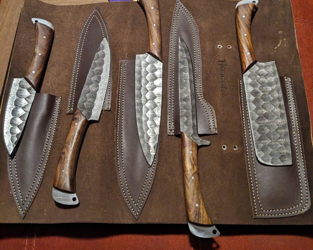 My wife's anniversary present to me. Handmade damascus kitchen knives with custom leather case.