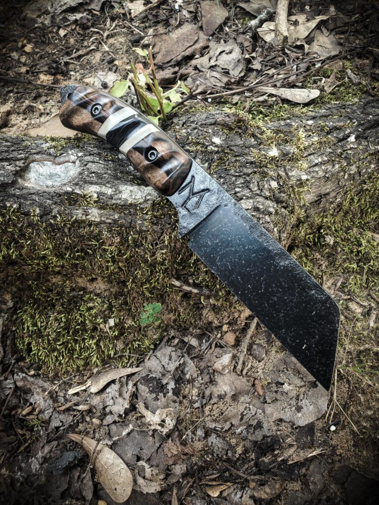 80crv2 with an Ebony Wood handle, carbon fiber and tan G10 split with black G10 liners.
