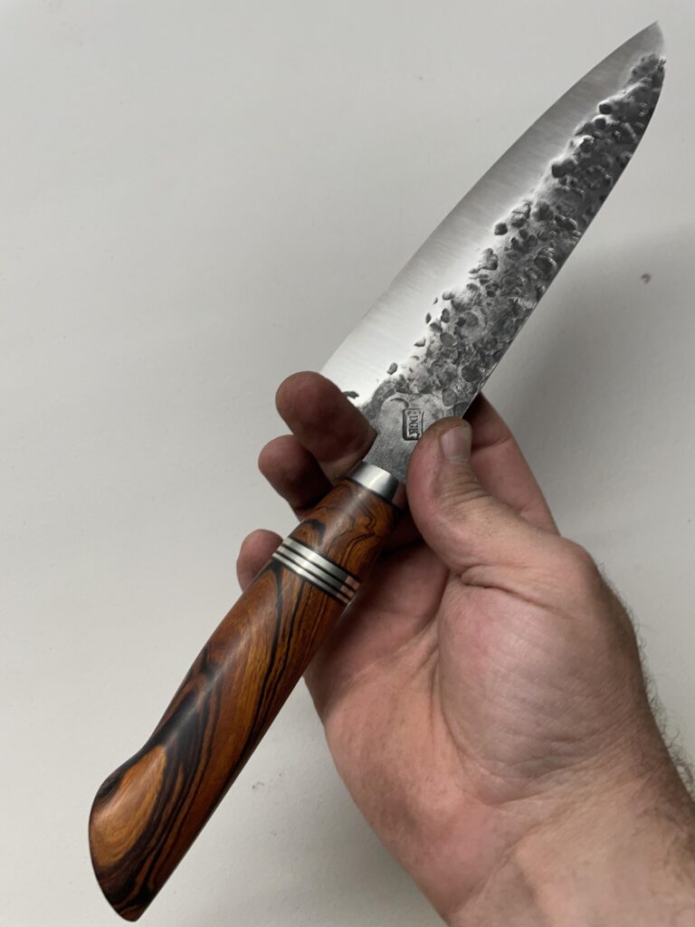 D2(60hrc), Titanium bolster ( forged), Desert Ironwood, nickel copper, fibre.