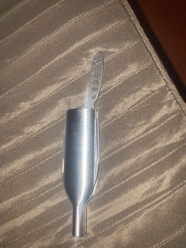 What is this dull knife like thing with holes used for? It should be some wine related toolkit