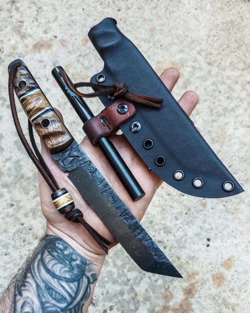 Wrapped up and ready for an edge. 80crv2 with Apocalyptic mango and Acacia wood, titanium pins, black G10 liners. 6 inch Ferro rod and matching bead.