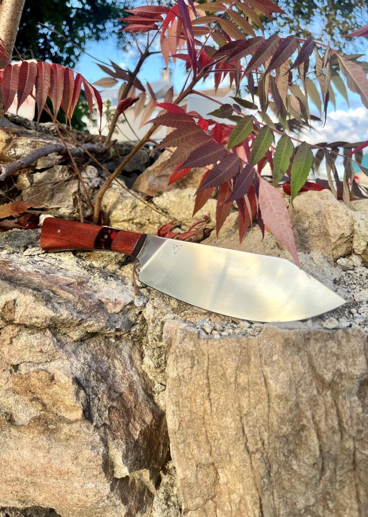 A recent work of mine. A stainless steel kitchen knife chopper. Steel is AEBL and the handle is bloodwood with acrylic accent and stainless steel pins. Thanks for looking!