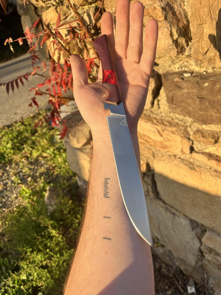 A recent work of mine. A kitchen knife made from W-1. Handle is purple heart and acrylic. Hope you guys like it and thanks for looking!