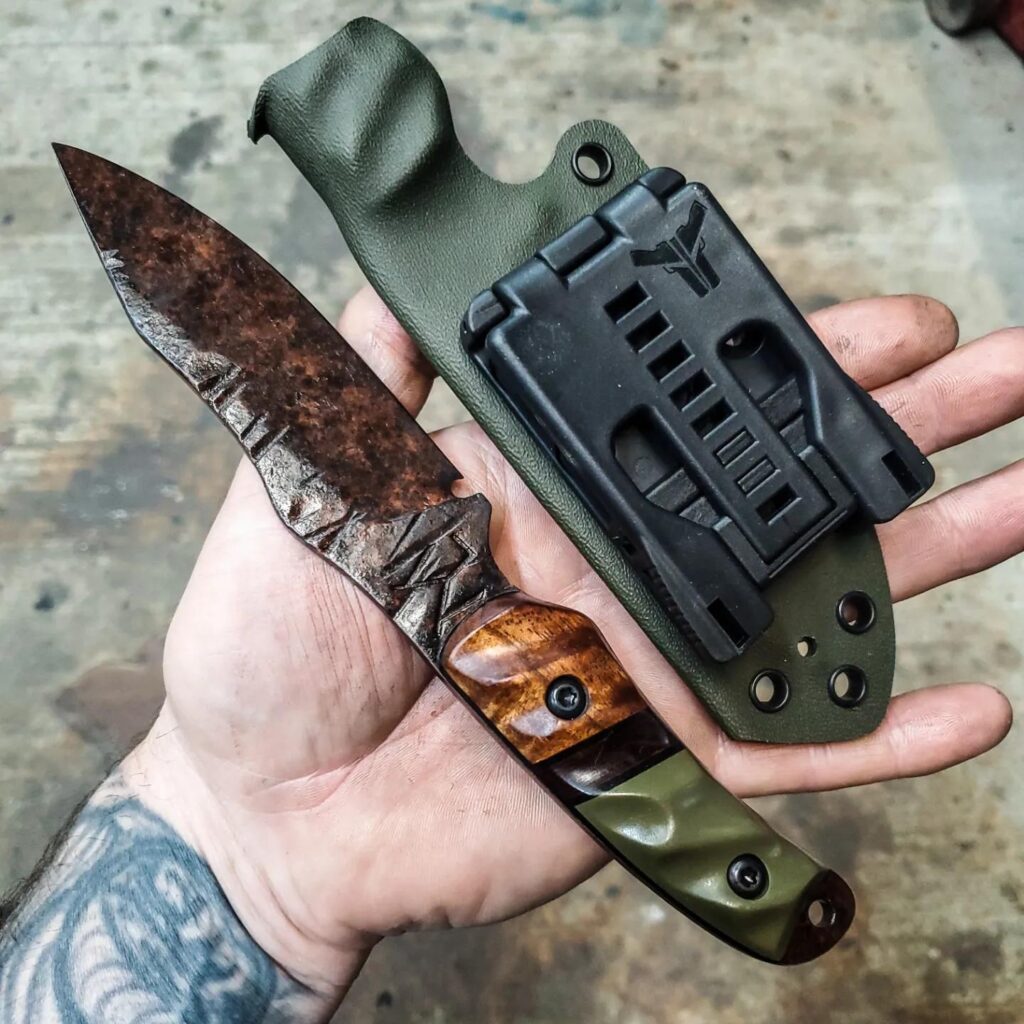 80crv2 with apocalyptic finish, Koa, OD green G10 with brick red and black layered G10 split, Black G10 liners.