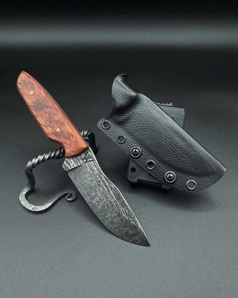 Check it out! One of a few I recently finished. Bubinga hardwood with copper pins. 80crv2 steel with a forged wood grain texture and an acid/stone wash.