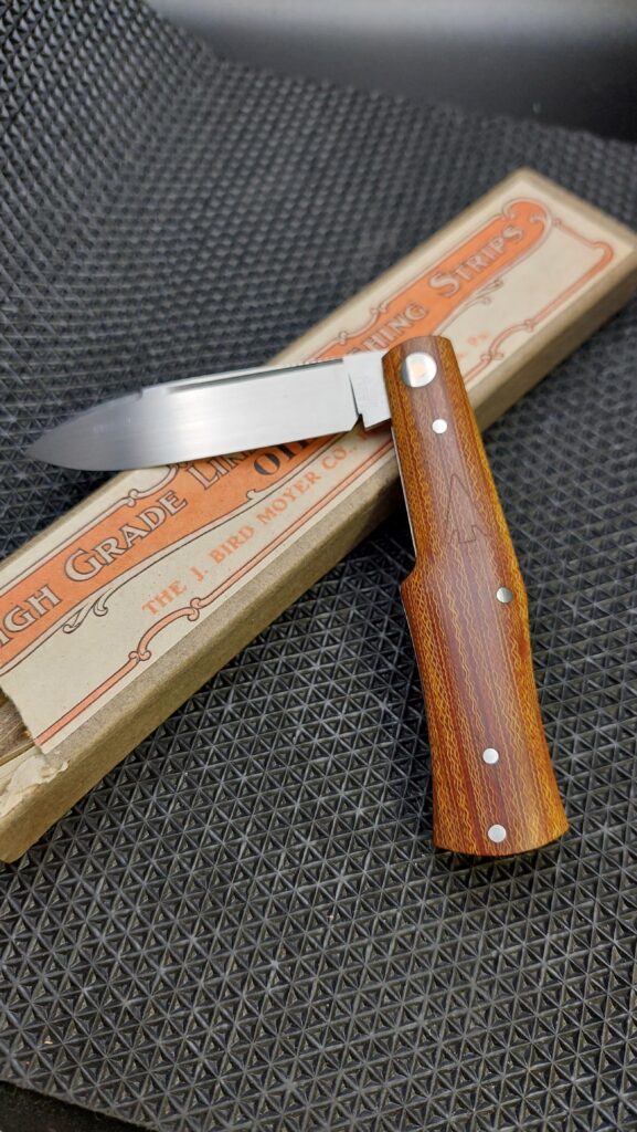 Handmade Gunstock in CPM-154 Vintage cross cut micarta shadow pattern/birdseye (ash.handmade.knives instagram)