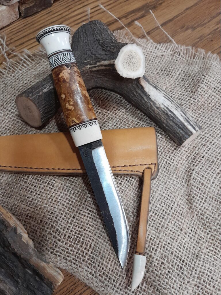 Handmade Finnish Puukko knife. Hand-forged Carbon steel blade. Antler and wood handle.