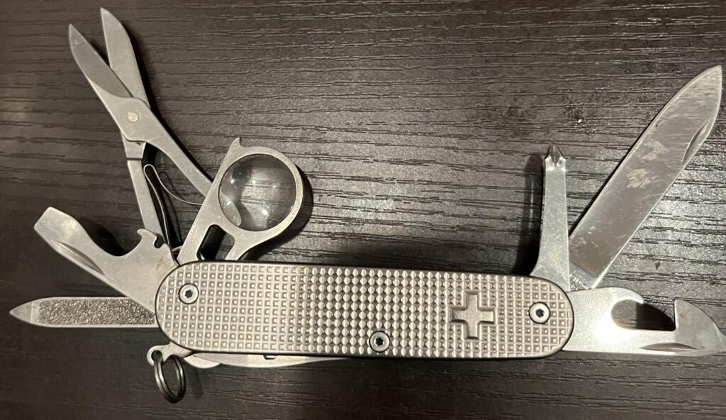 My EDC for several years. Custom Vic Explorer with titanium scales, titanium magnifying glass frame, and nail file instead of small blade.