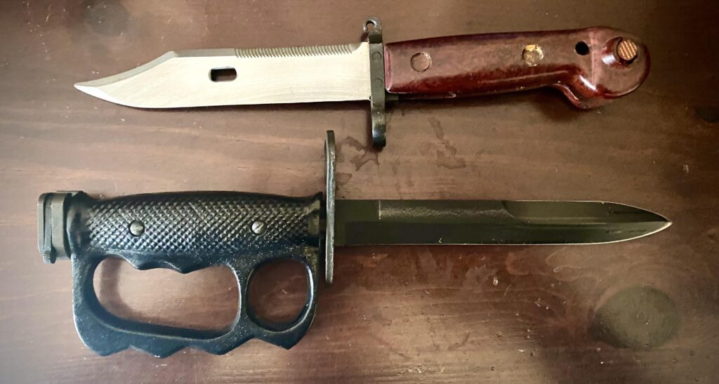 Unsheathed bayonets. The hole in the top AK bayonet attaches to its sheath the become a makeshift wire cutter.