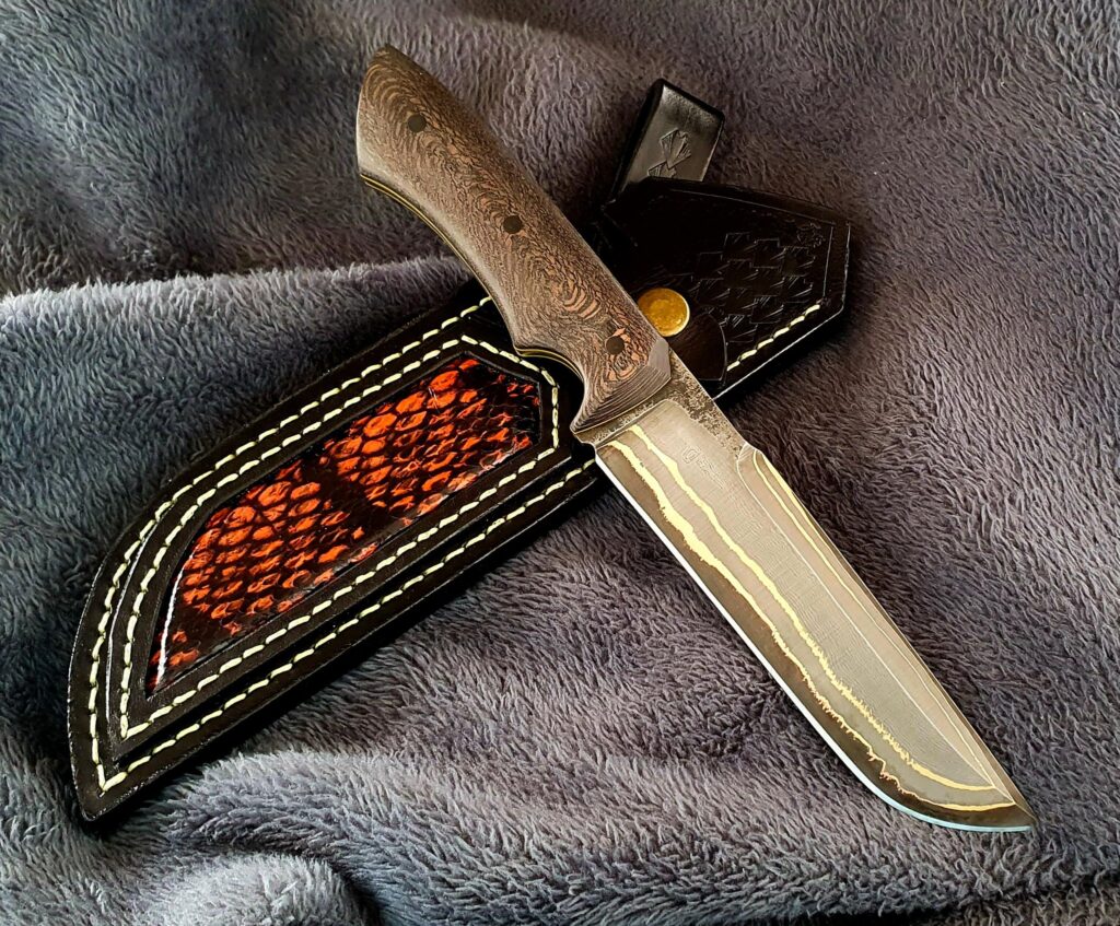 Decided to give this knife some loving with better pics as it deserves. Bronze-mai Damascus with 52100 core and stabilized wood. Share your thoughts.