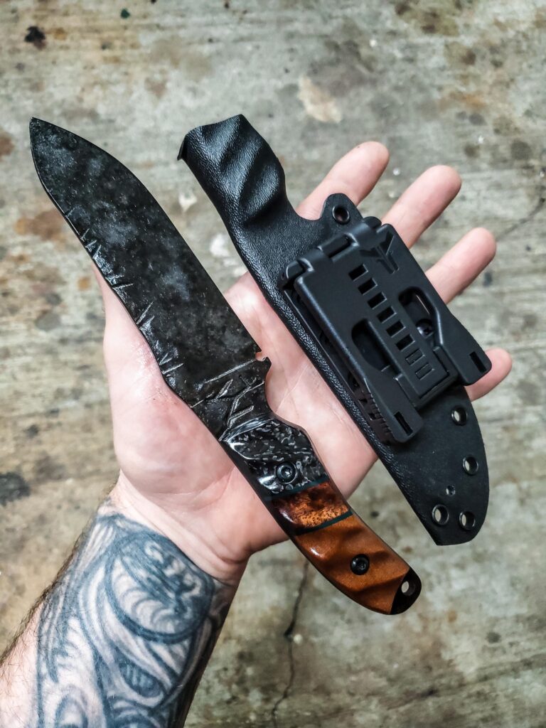 80crv2, Granite finish with carbon fiber and natural linen micarta with forest green G10 and koa split.
