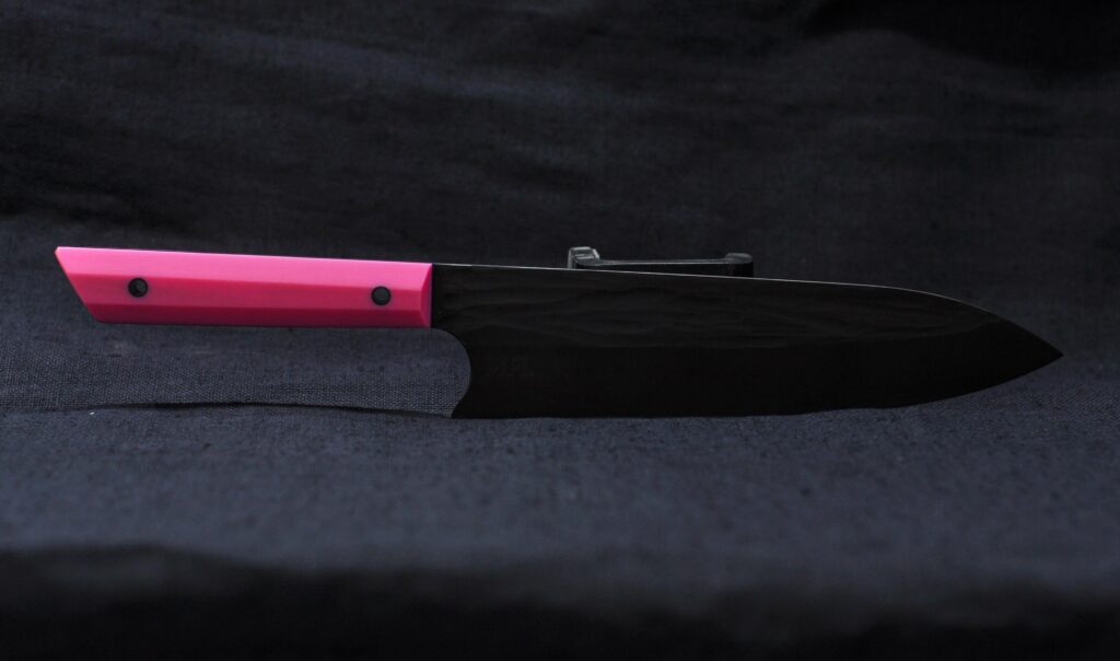 Simple Gyuto I just finished. 52100 @ 64RC, pink micarta with purple liners, carbon tube pins