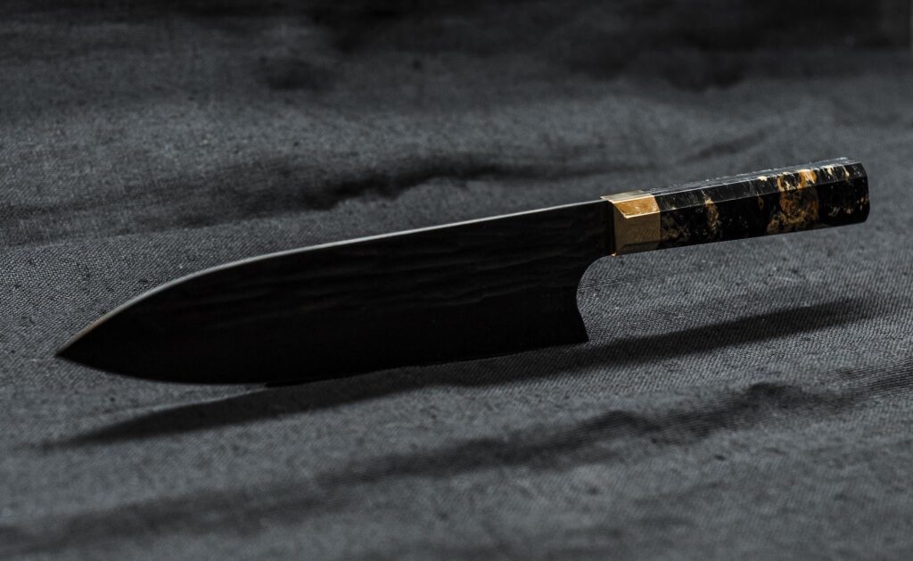 A 21cm full tang gyuto I made. 52100 steel @ 64HRC, stabilized maple burl with a brass bolster