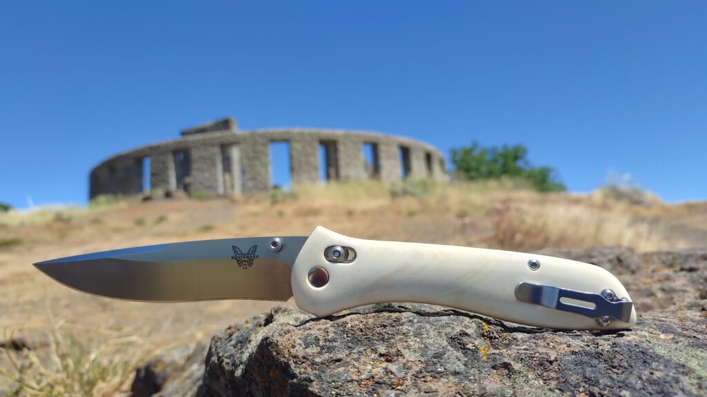 Road trip carry in the Columbia River Gorge. In the background, an exact replica of Stonehenge in size & orientation. In the foreground, my version of a 20th anniversary 710 in D2, hand polished walrus ivory & hand polished hardware/Axis/pivot/clip