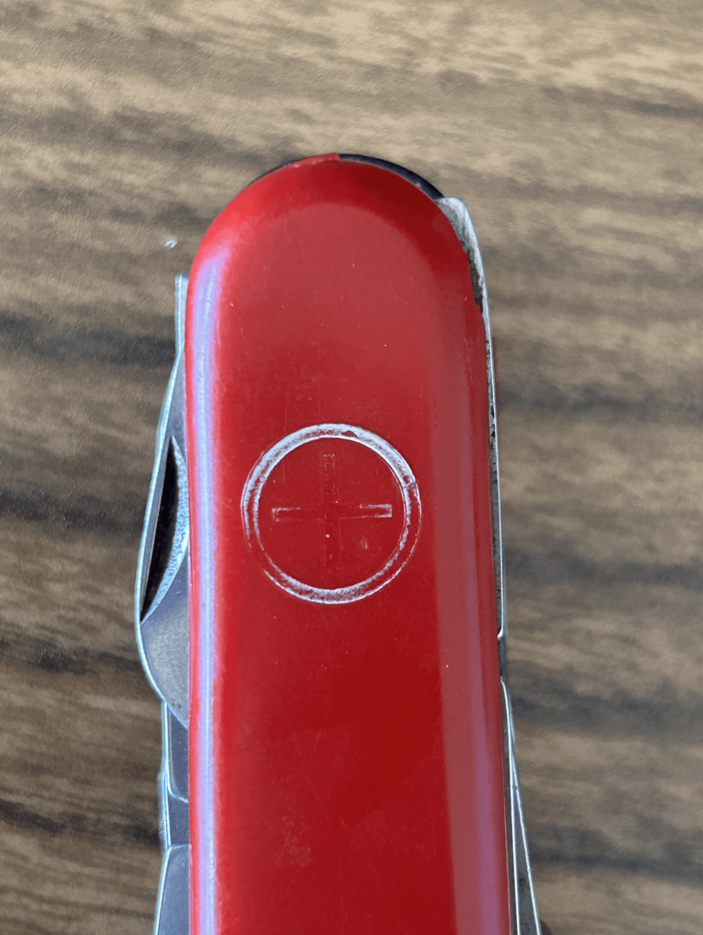 ID of this tool/brand? Received this tool from my grandfather and was wondering what brand it is. I assumed it was a swiss army knife from the cross logo, but after some research I found that they never used this logo. It is also quite old, so I was also wondering if anyone knows its age. Thanks!