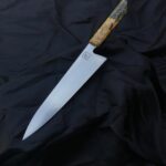 225x56 Walkschliff and light convex ground Gyuto in stainless 14c28n deep cryo hardened to 61.5 Hrc. Classic framehandle made of G10, Nickelsilver pins and in house stabilized Buckeyeburl. Love how this one turned out! So much I might do a little production series of these with different handle mate