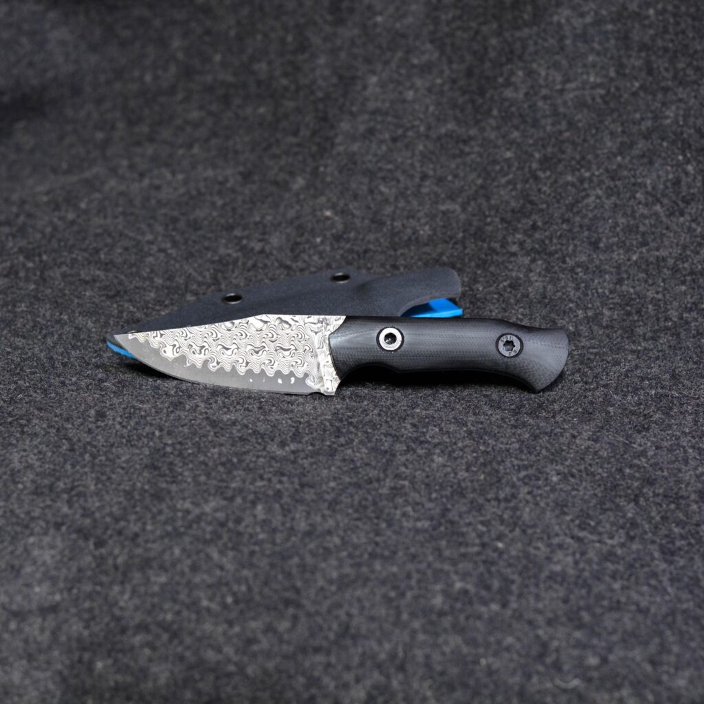 Three finger clip point Stainless Damascus laminate that I just finished