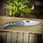 Just finished up this new front flipper crossbar folder in Carbon Fiber and MagnaCut. More playing around with some handle cutouts and laser images…Not sure what to name this one?