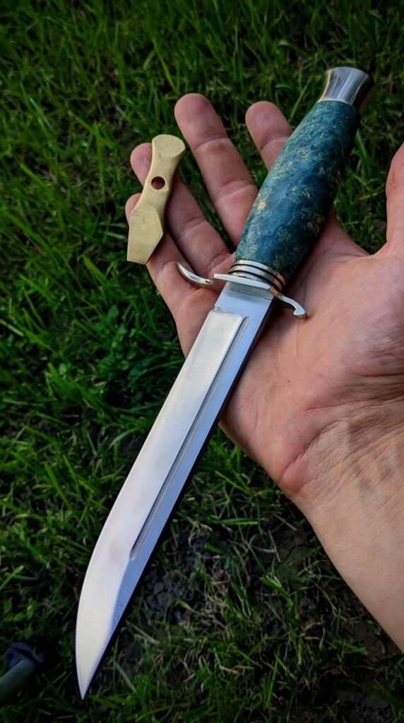 Finished this aquamarine 5.90 inch long Finka knife for a customer today! Made it with n690 steel, heat treated to 60 hrc. Stabilized maple burl and nickel silver. What do you thing of it?