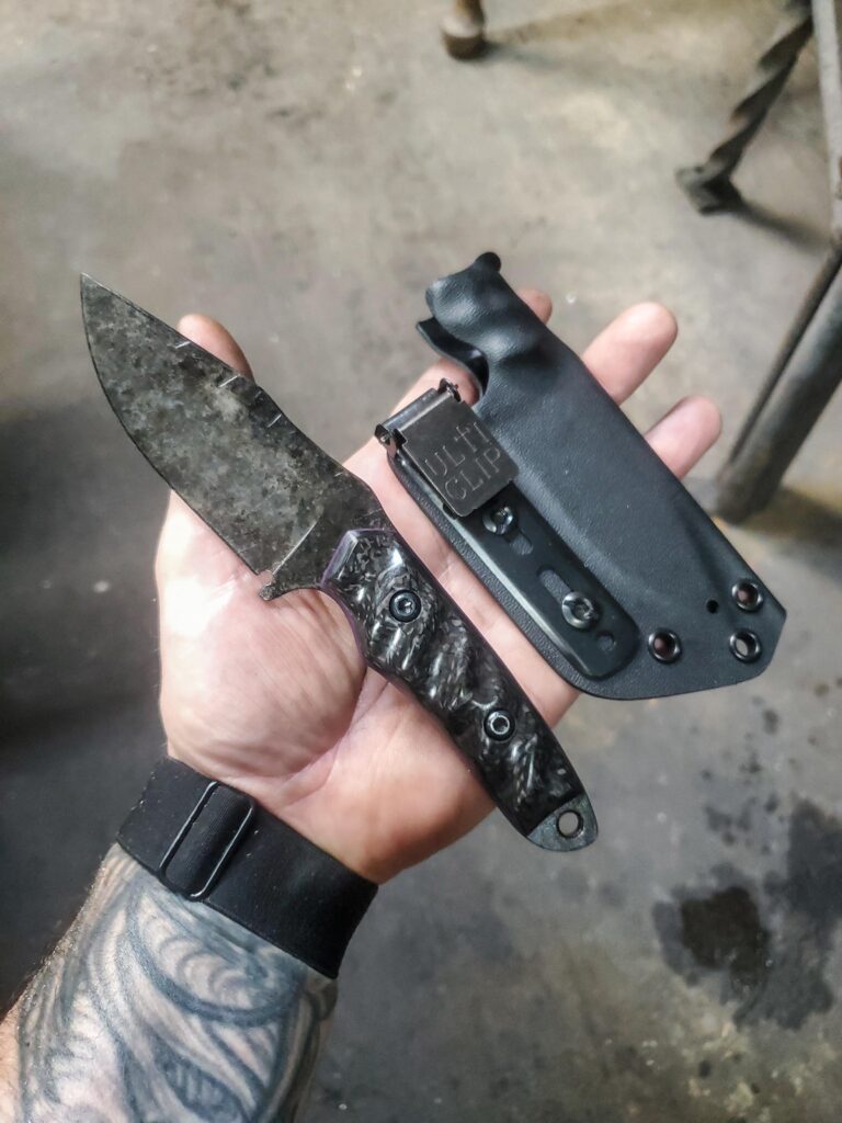 80crv2 granite finish with carbon fiber and Royal purple G10 liners.