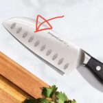 Why do some chefs knives have bumps on the blade?
