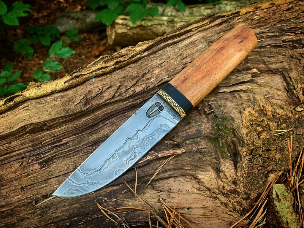 Low layered damascus knife made by Hellize Ironworks
