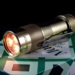 [NMD] Brass FW3A mod with 1800K FFL351A emitters and 3 channels of orange aux LEDs.