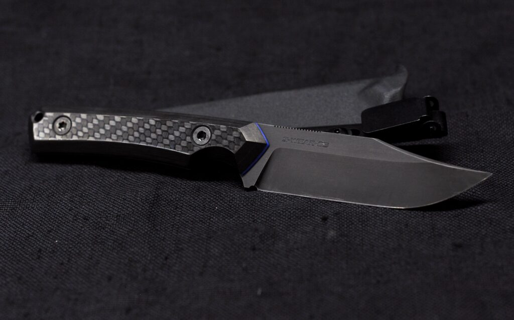 A stealthy EDC bowie just finished. Z-Wear @ 63HRC, carbon and some blue liners