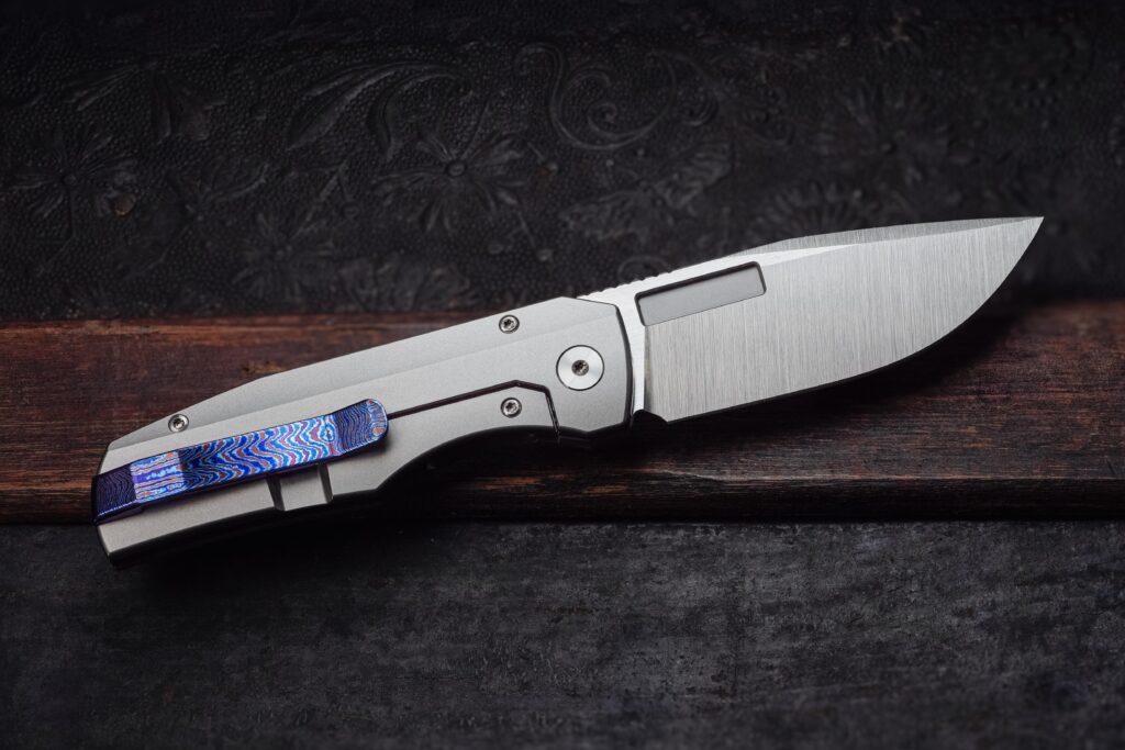 Vero Engineering Nova, clip side with Timascus. Magnacut blade with belt satin finish