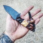 80crv2 with Koa, old growth Red wood and box elder split. Royal purple G10 liners.