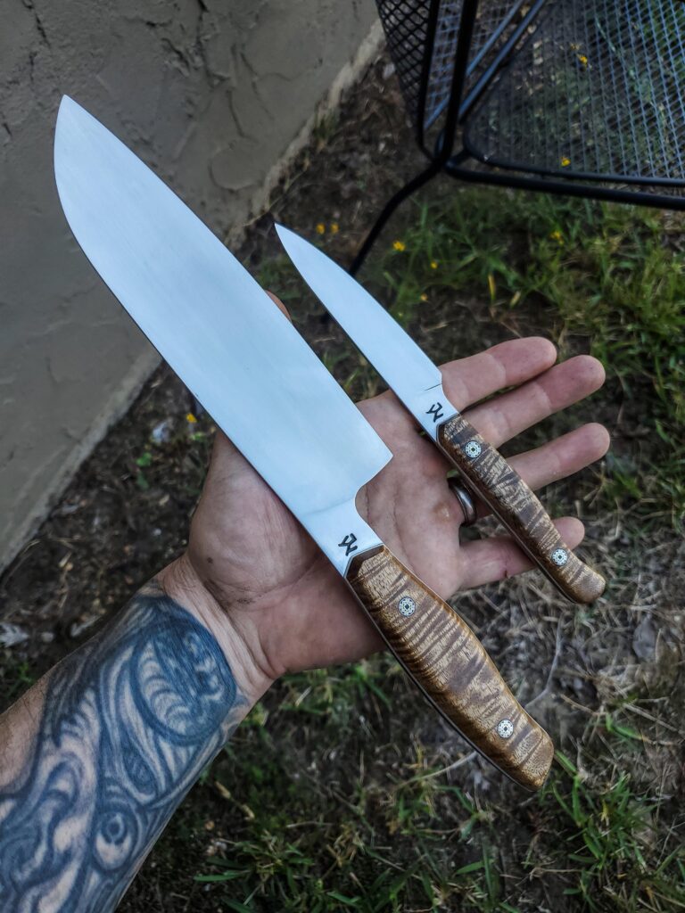 AEB-L santoku with pairing knife Acacia handle and mosaic pins with white G10 liners.