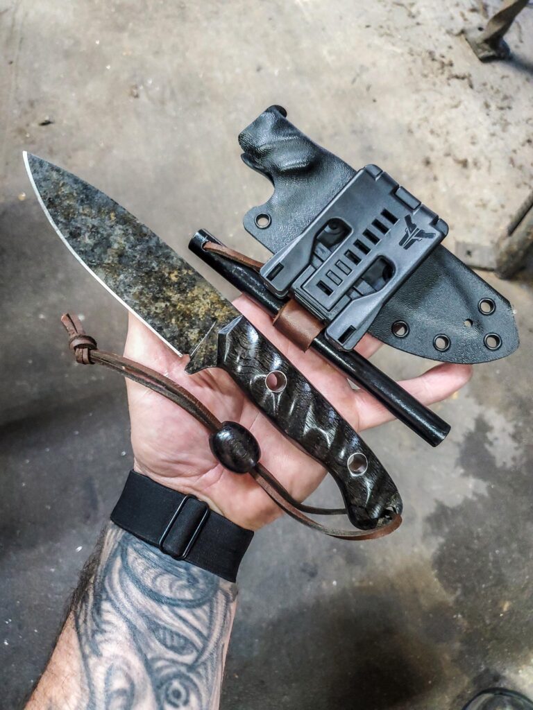 Bushcraft blade in AEB-L with Granite finish and Ancient Bog Oak, hollow titanium pins and Black G10 liners.