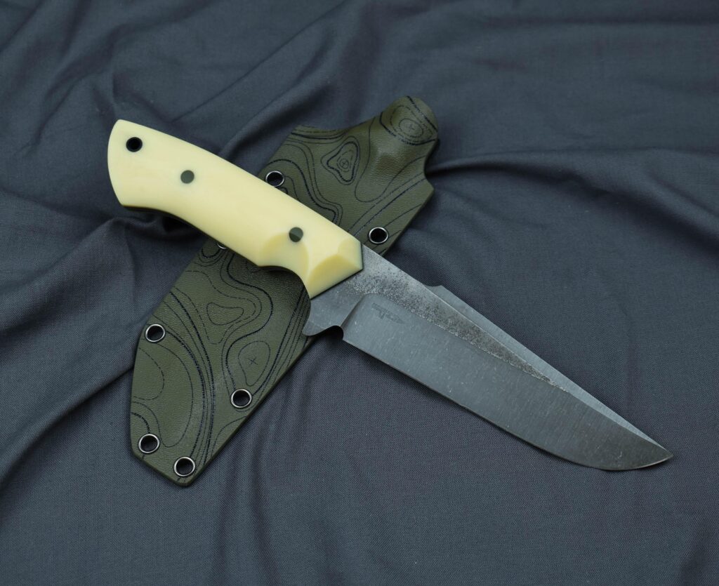 Stonewashed ELMAX with cryo at 61HRC, ivory micarta, G10 pins, tube and liners, kydex sheath. What do you think?