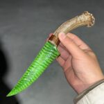 Artificial green cat's eye stone indoors and at night