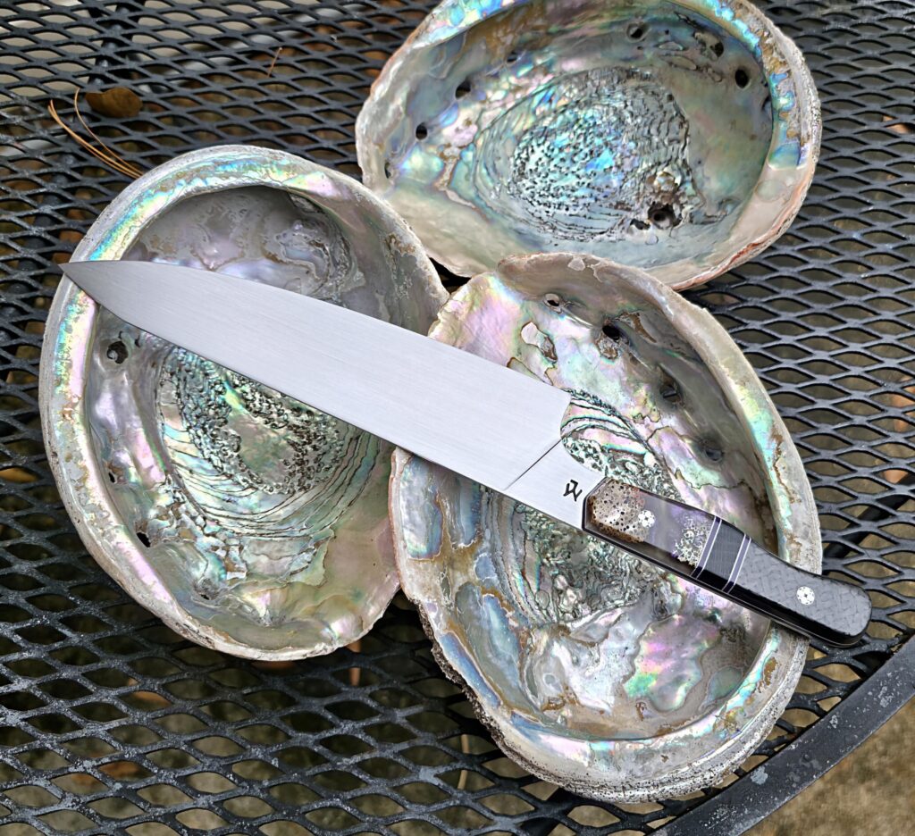 I finished this one up.15n20 Chef knife with Abalone and resin and carbon fiber. The split is Ancient Bog Oak 👍