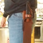 Hand made Mandalorian Beskad and sheath. This sheath is particularly interesting because the blade is so long it can't be lifted straight out, so there is a lift and rock mechanism.