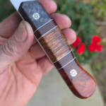 AEB-L Stainless with Amboyna Burl and carbon fiber handle with carbon fiber. The split is made with Curly Koa and burlap Micarta. White G10 liners and mosiac pins. 🤙