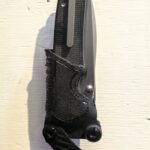 made a kydex auto opener sheath with locking/opening swing arm catch