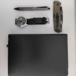 Knife, mechanical pencil, watch and notebook.
