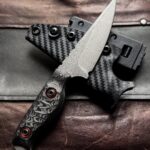 Made this N690 fighter. 7.7" OA. Carbon fiber scales with orange G10