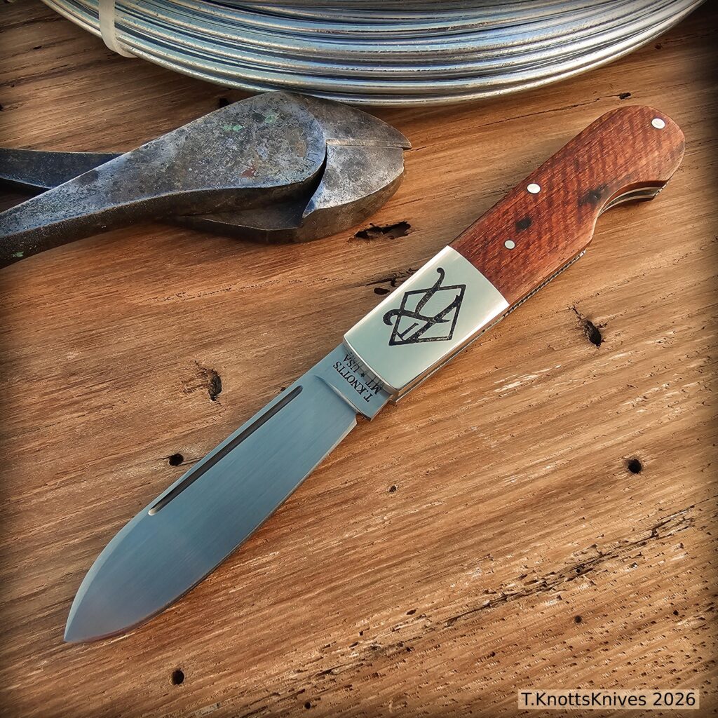 Spear point Barlow with Narra wood covers.