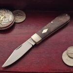 Clip point in O1 with Walnut covers.